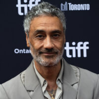 Taika Waititi at the 2023 Toronto International Film Festival, wearing a grey suit.