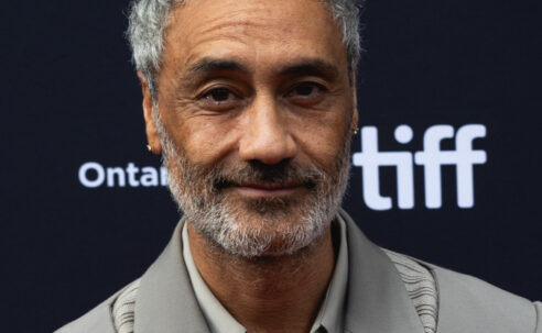 Taika Waititi at the 2023 Toronto International Film Festival, wearing a grey suit.