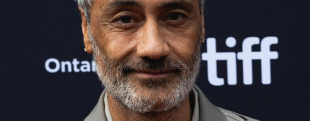 Taika Waititi at the 2023 Toronto International Film Festival, wearing a grey suit.