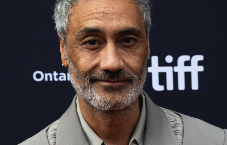 Taika Waititi at the 2023 Toronto International Film Festival, wearing a grey suit.