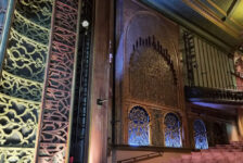 Ornate auditorium at Soho Theatre Walthamstow in London, featuring decorative walls, a balcony and rows of cinema seats.