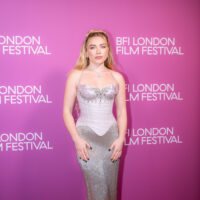 Florence Pugh at the 2026 BFI London Film Festival in a silver gown against a pink backdrop.