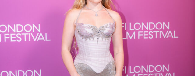 Florence Pugh at the 2026 BFI London Film Festival in a silver gown against a pink backdrop.