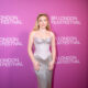Florence Pugh at the 2026 BFI London Film Festival in a silver gown against a pink backdrop.